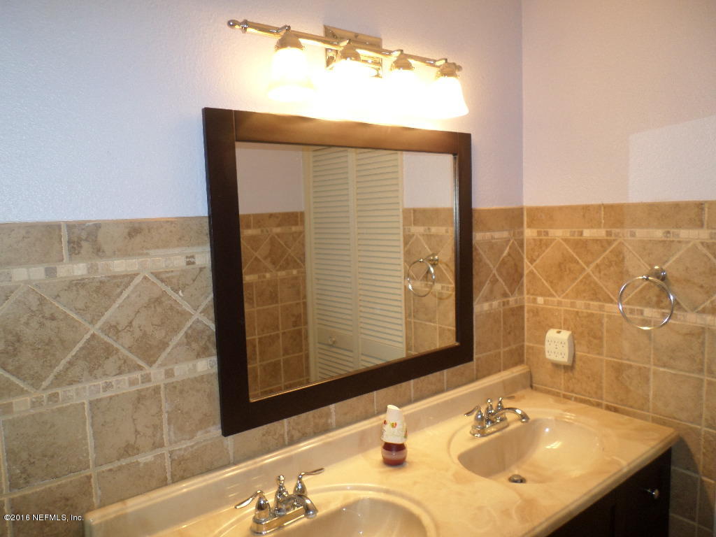 4237 Stacey Road Jacksonville, FL 32250 - Photo 18 of 22 a bathroom with a sink vanity and a mirror