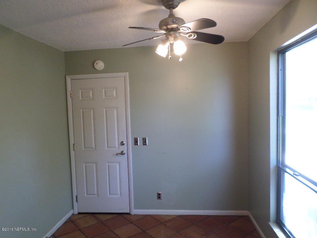 4237 Stacey Road Jacksonville, FL 32250 - Photo 19 of 22 an empty room with windows and fan
