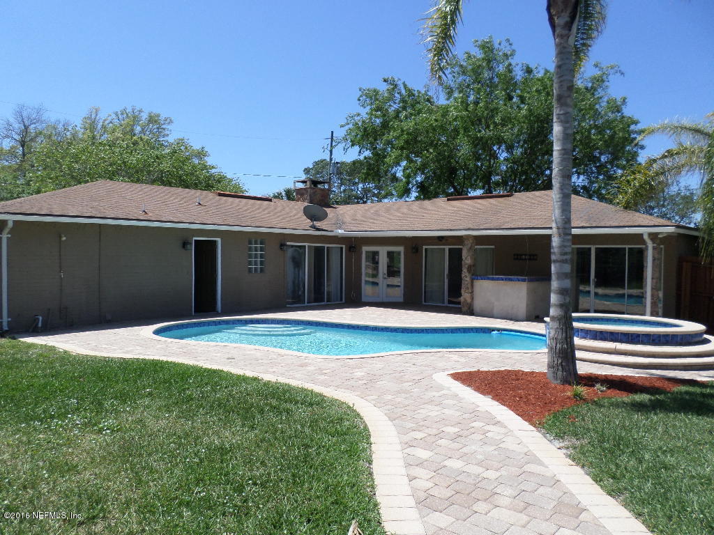 4237 Stacey Road Jacksonville, FL 32250 - Photo 2 of 22 a view of a white house with a yard and a large tree