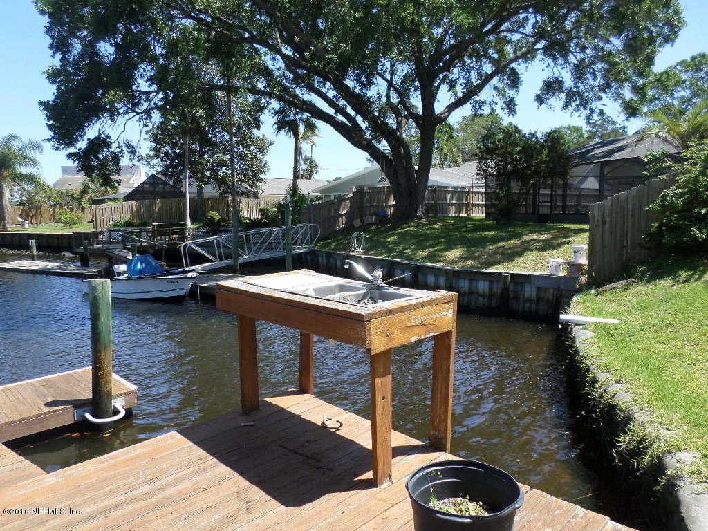 4237 Stacey Road Jacksonville, FL 32250 - Photo 4 of 22 a view of a swimming pool with a patio and a yard