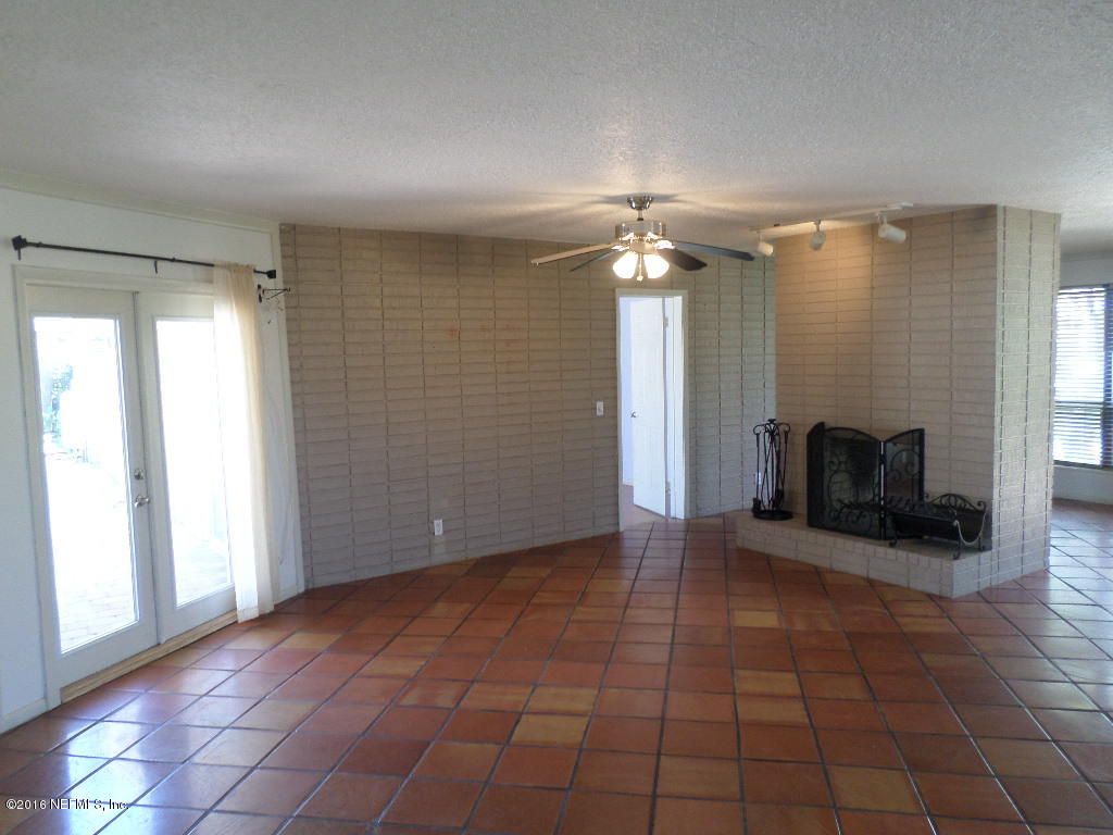 4237 Stacey Road Jacksonville, FL 32250 - Photo 6 of 22 an empty room with fireplace and windows