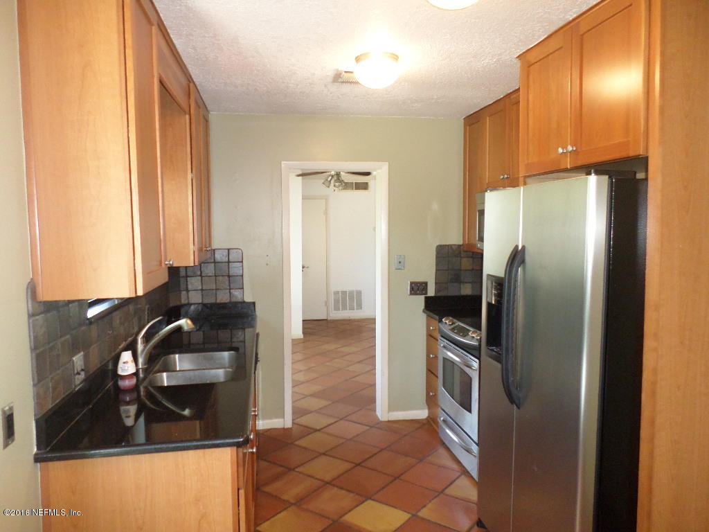 4237 Stacey Road Jacksonville, FL 32250 - Photo 9 of 22 a kitchen with stainless steel appliances granite countertop a refrigerator and a sink