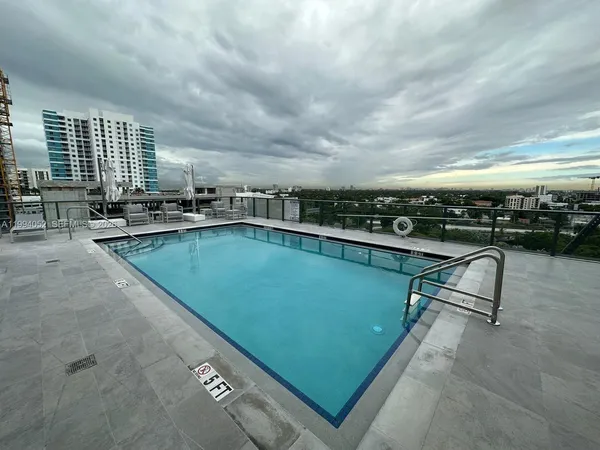 a view of a swimming pool with outdoor seating