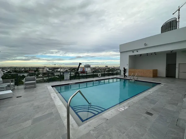 a view of a swimming pool with an outdoor seating
