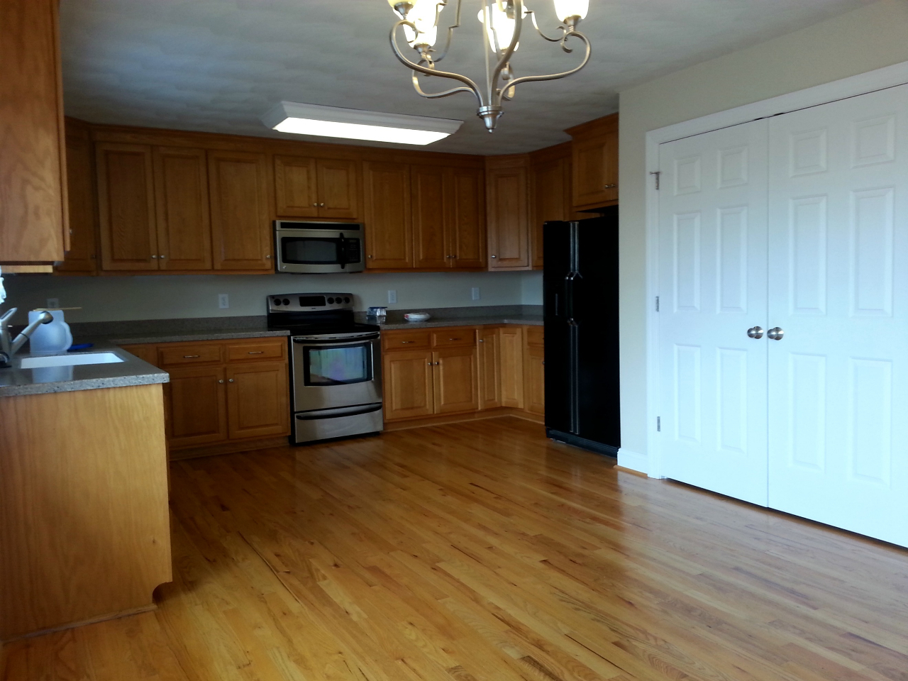 5191 Horseshoe Bend Road Goodview, VA 24095 - Photo 5 of 8 a kitchen with stainless steel appliances granite countertop a refrigerator a sink dishwasher a stove and a microwave oven on granite countertops
