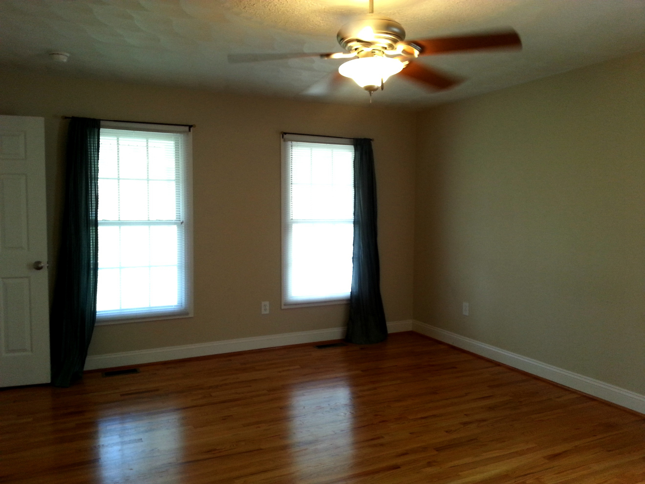 5191 Horseshoe Bend Road Goodview, VA 24095 - Photo 8 of 8 an empty room with wooden floor and windows