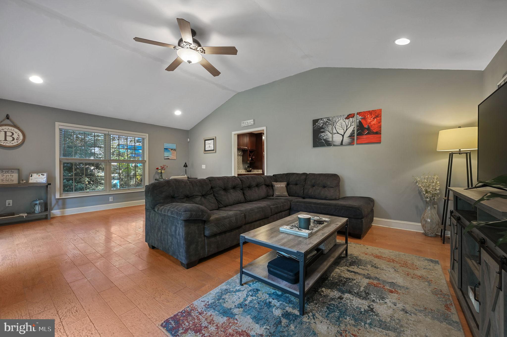 196 Mifflin Road Dover, DE 19904 - Photo 14 of 27 a living room with furniture a chandelier and a flat screen tv