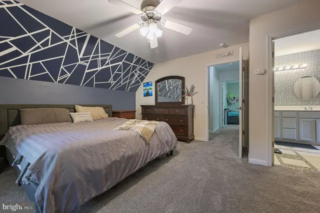 a spacious bedroom with a bed and a chandelier