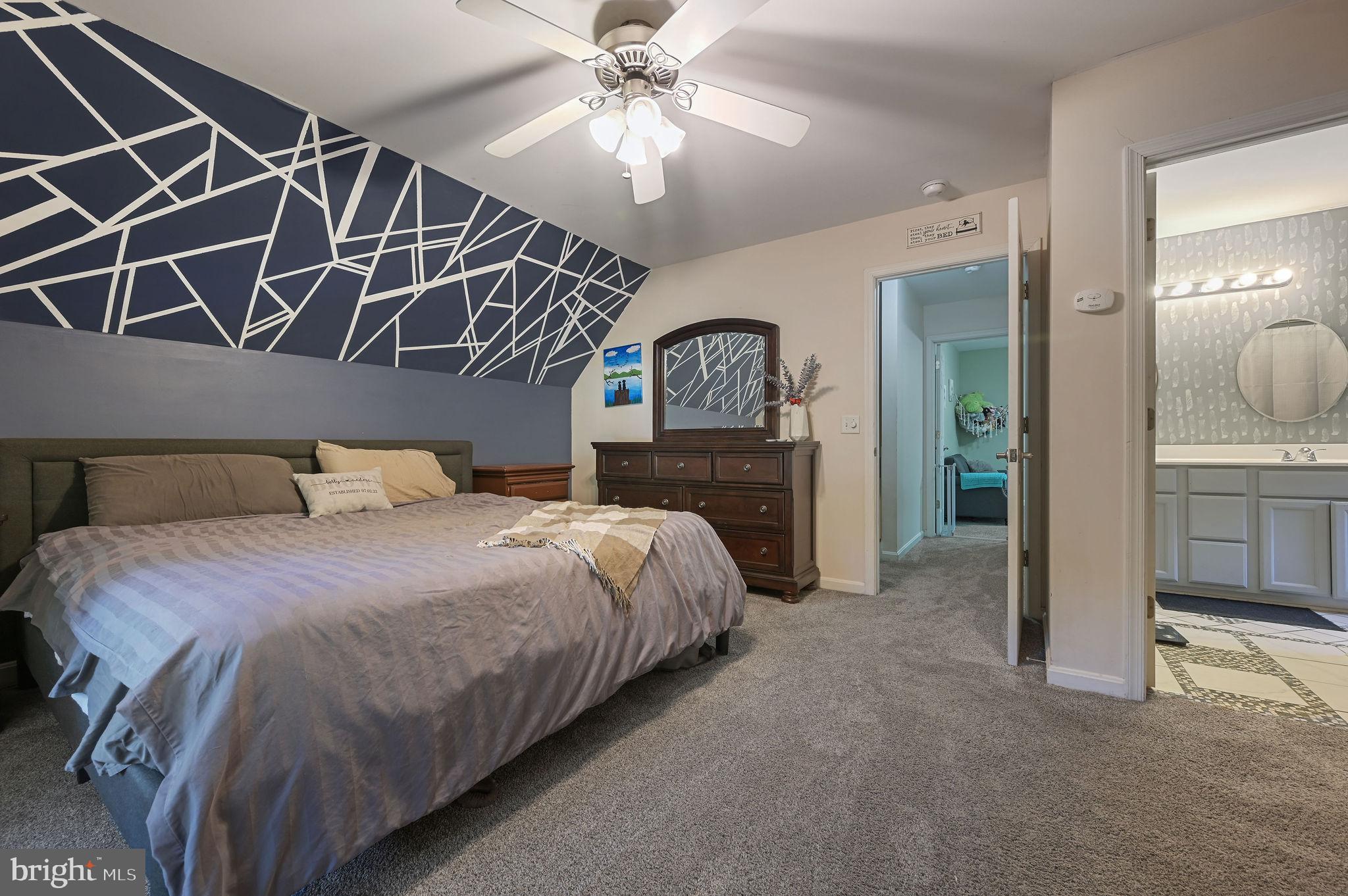 196 Mifflin Road Dover, DE 19904 - Photo 20 of 27 a spacious bedroom with a bed and a chandelier