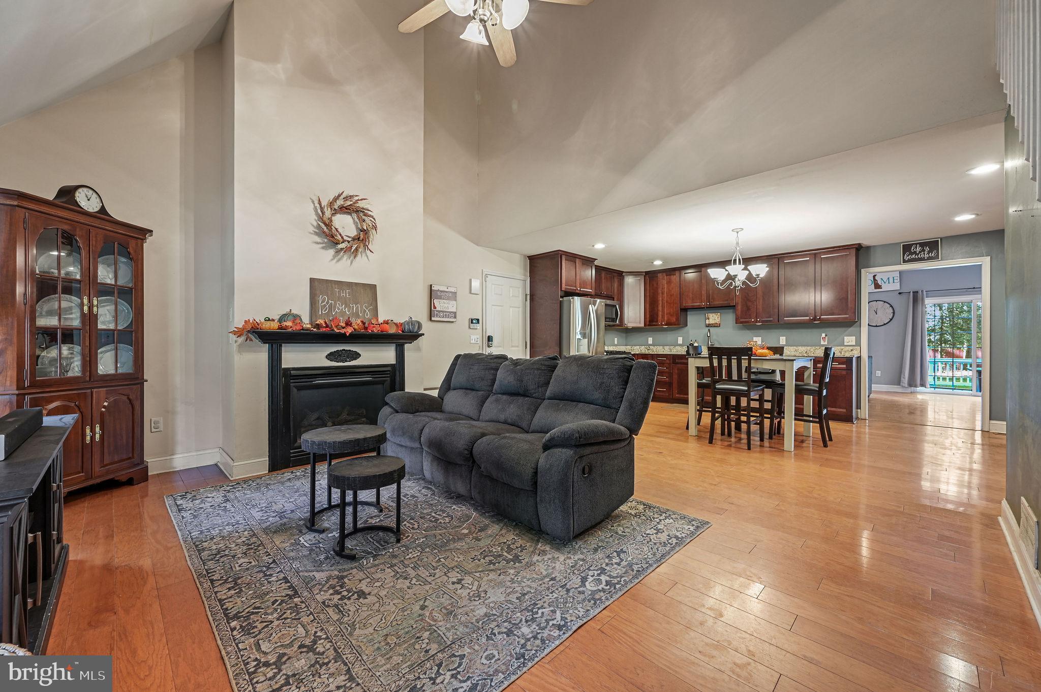 196 Mifflin Road Dover, DE 19904 - Photo 3 of 27 a living room with furniture a wooden floor and next to a rug