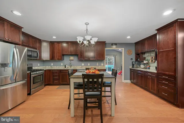 a kitchen with a refrigerator and a dining table
