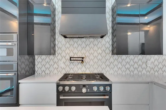 a view of a hallway with wooden floor and a potted plant on a wall