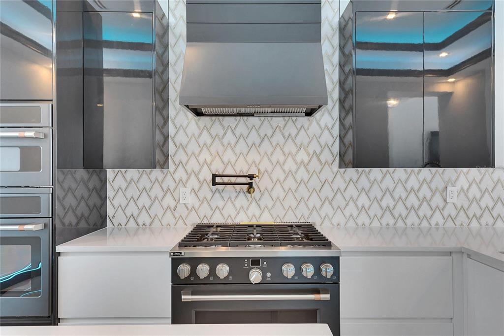 6538 Simone Shores Circle Apollo Beach, FL 33572 - Photo 27 of 88 a stove top oven sitting inside of a kitchen