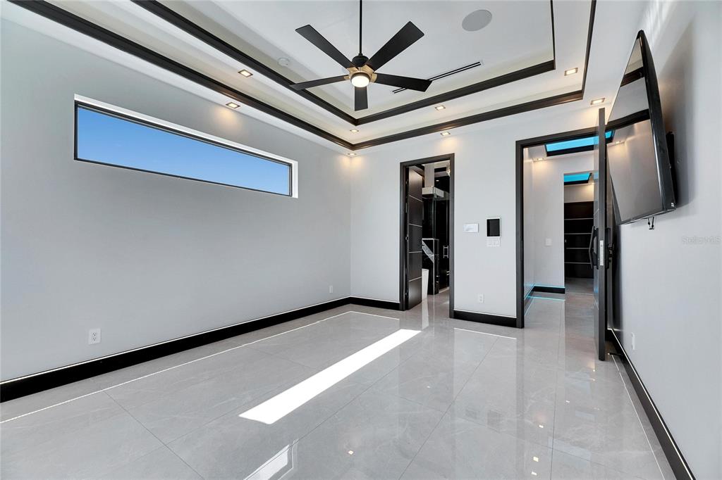 6538 Simone Shores Circle Apollo Beach, FL 33572 - Photo 32 of 88 a view of a livingroom with a ceiling fan and kitchen space