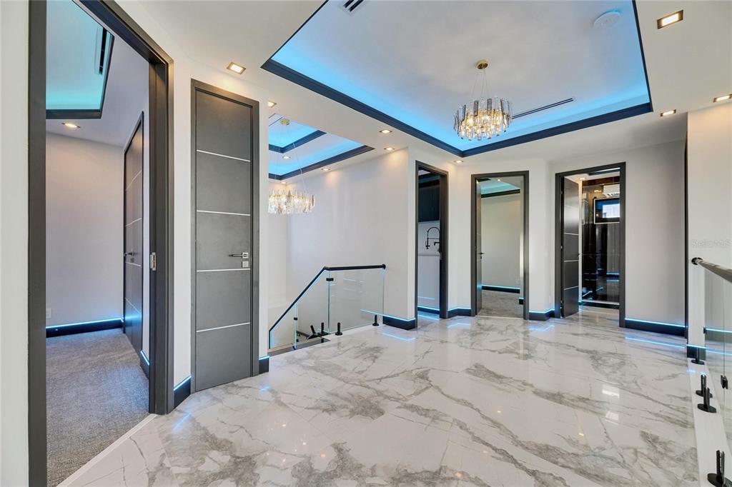 6538 Simone Shores Circle Apollo Beach, FL 33572 - Photo 44 of 88 a view of a hallway with a chandelier