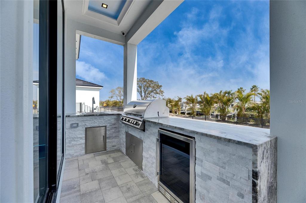 6538 Simone Shores Circle Apollo Beach, FL 33572 - Photo 69 of 88 a kitchen with stainless steel appliances granite countertop a stove a sink and a refrigerator