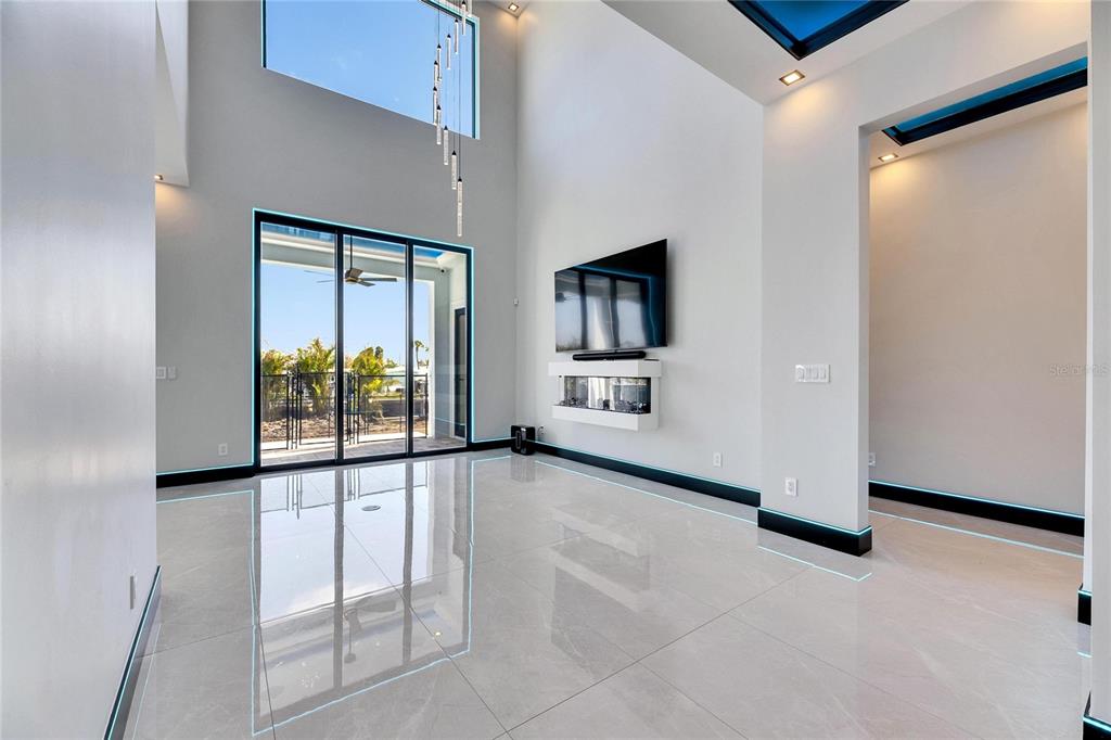6538 Simone Shores Circle Apollo Beach, FL 33572 - Photo 9 of 88 a view of a livingroom with furniture and a flat screen tv
