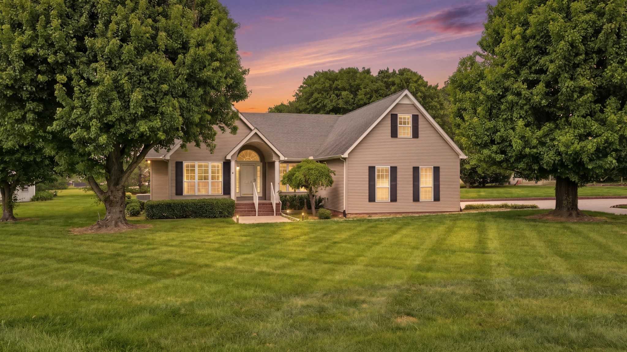 213 Maple Springs Drive Manchester, TN 37355 - Photo 1 of 58 a front view of a house with a garden