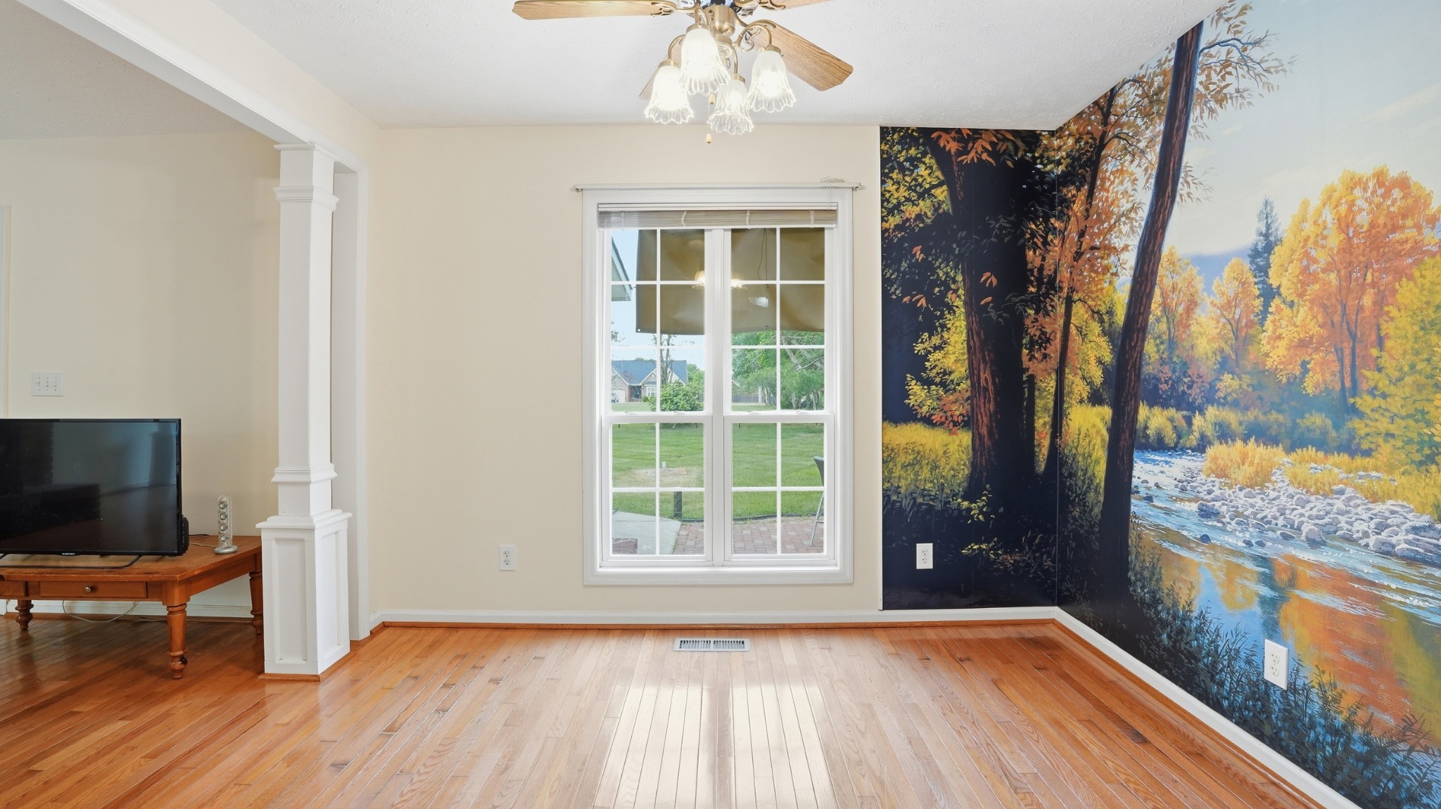 213 Maple Springs Drive Manchester, TN 37355 - Photo 11 of 58 a view of an empty room with a window and wooden floor