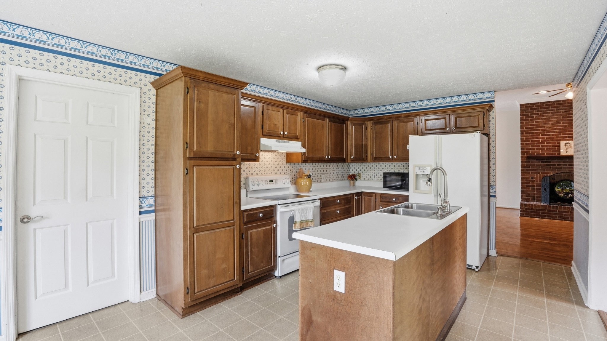 213 Maple Springs Drive Manchester, TN 37355 - Photo 12 of 58 a kitchen with a refrigerator a stove top oven and cabinets