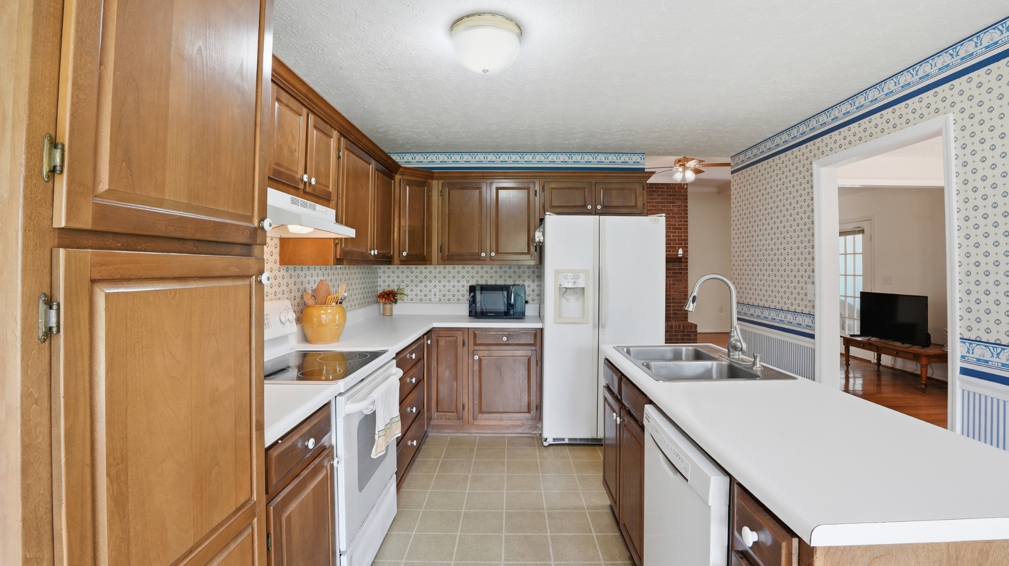 213 Maple Springs Drive Manchester, TN 37355 - Photo 13 of 58 a kitchen with white cabinets and stainless steel appliances