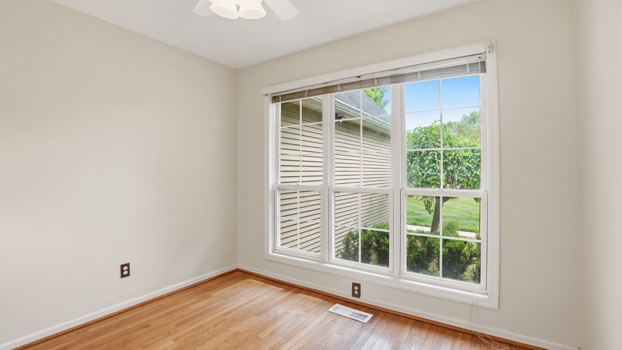 213 Maple Springs Drive Manchester, TN 37355 - Photo 21 of 58 a view of an empty room with wooden floor and a window