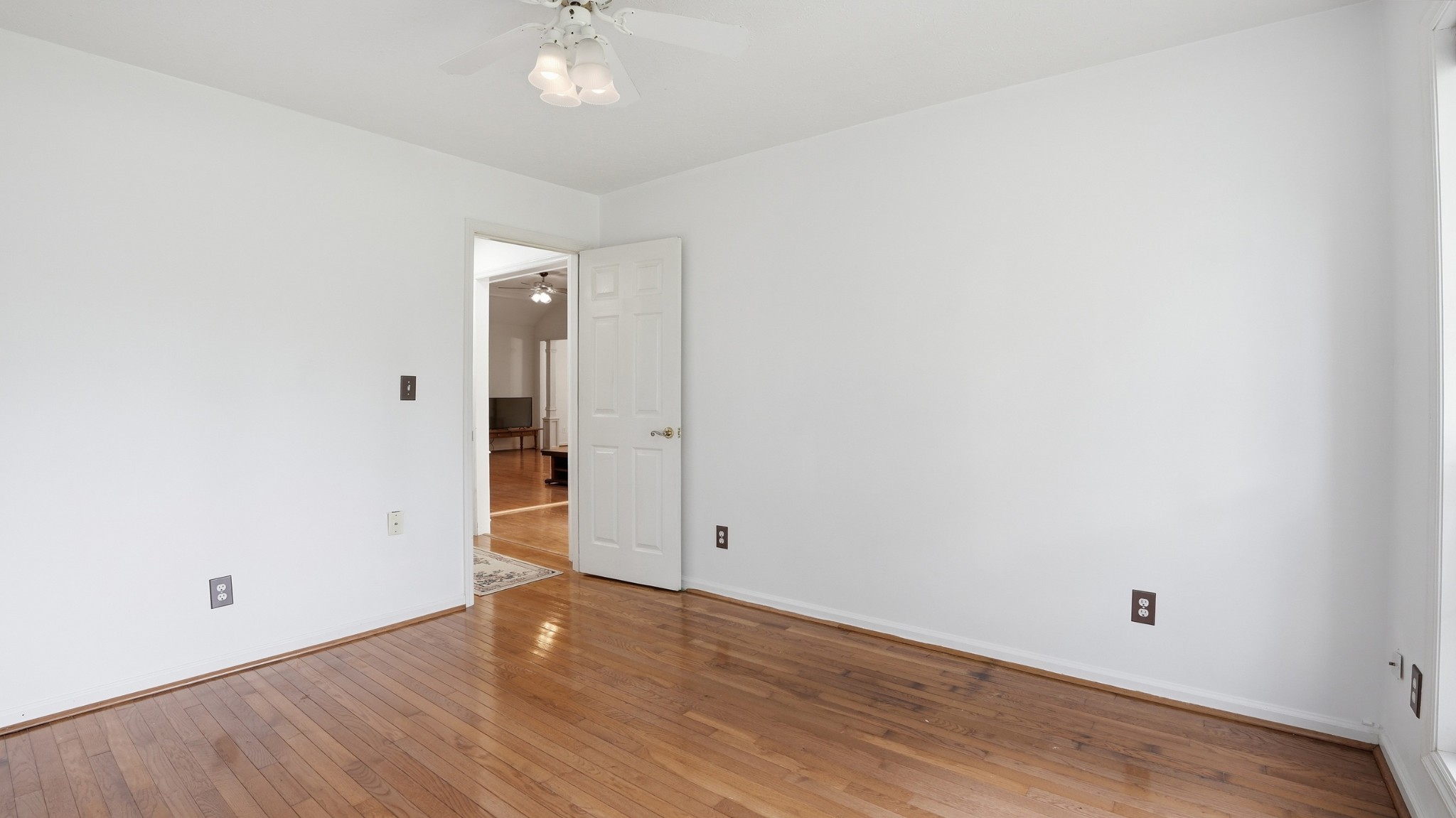 213 Maple Springs Drive Manchester, TN 37355 - Photo 24 of 58 an empty room with wooden floor and natural light