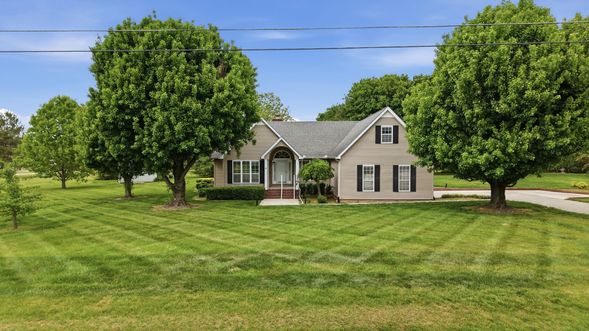 213 Maple Springs Drive Manchester, TN 37355 - Photo 39 of 58 a front view of a house with a yard