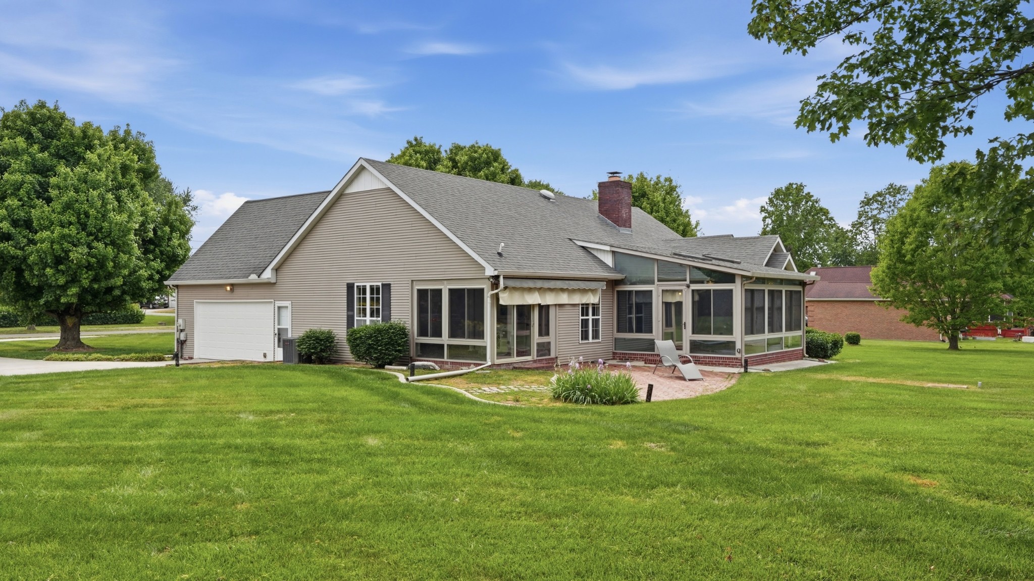 213 Maple Springs Drive Manchester, TN 37355 - Photo 44 of 58 a front view of a house with a garden and trees
