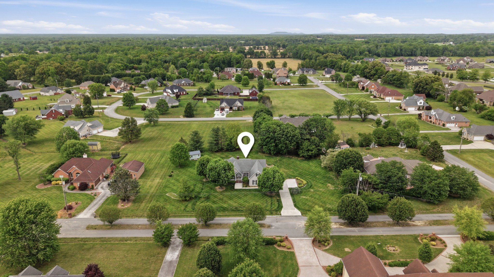 213 Maple Springs Drive Manchester, TN 37355 - Photo 53 of 58 an aerial view of green landscape with trees houses and lake view