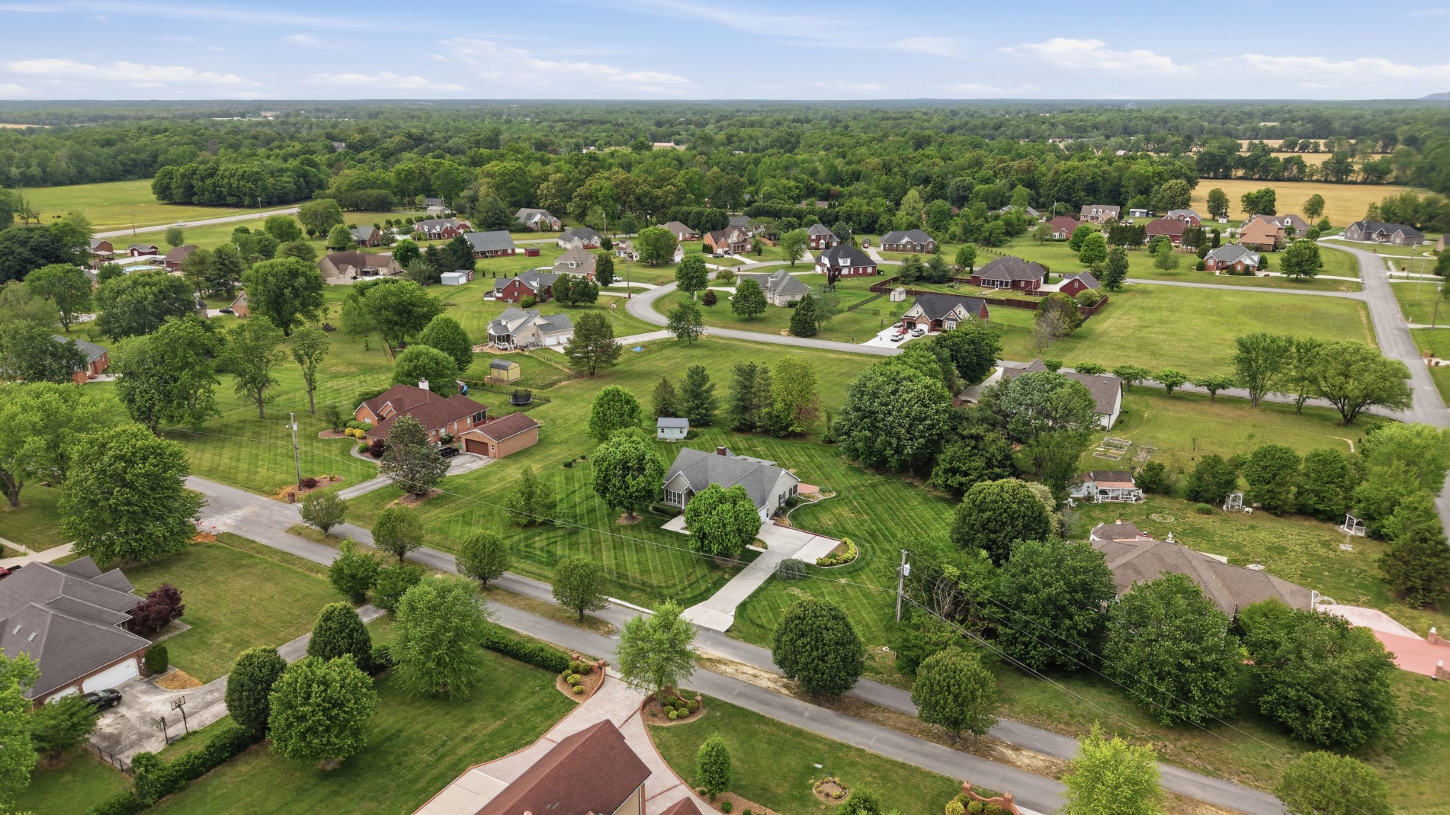 213 Maple Springs Drive Manchester, TN 37355 - Photo 55 of 58 an aerial view of residential houses with outdoor space and trees