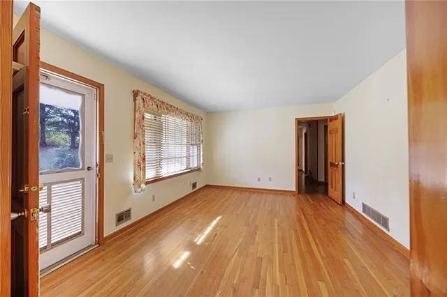 a view of an empty room with glass door