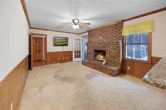 a view of a livingroom with an empty space and a fireplace