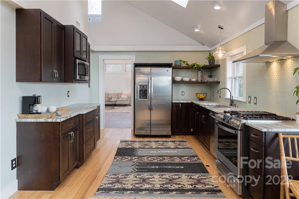 170 South Delano Road Asheville, NC 28805 - Photo 15 of 48 a kitchen with stainless steel appliances granite countertop a stove a sink and a refrigerator