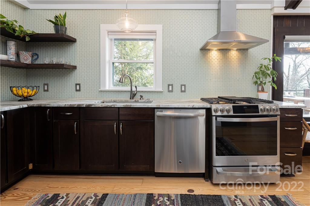 170 South Delano Road Asheville, NC 28805 - Photo 16 of 48 a kitchen with stainless steel appliances a stove a sink and a microwave
