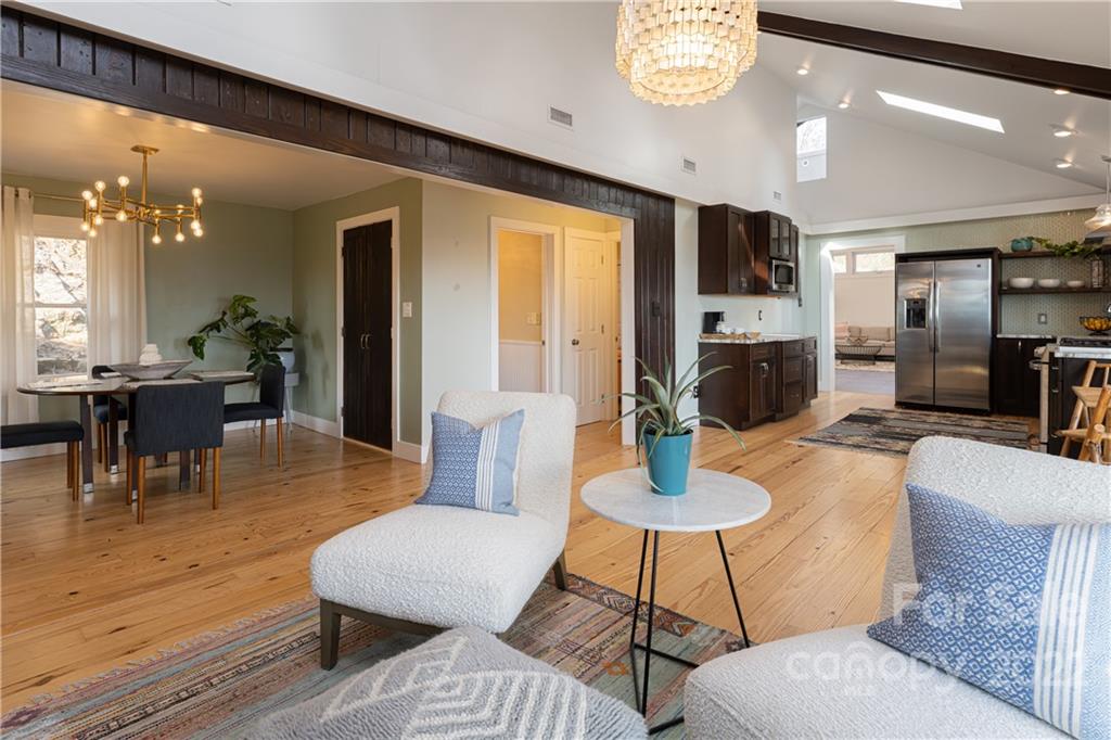 170 South Delano Road Asheville, NC 28805 - Photo 21 of 48 a living room with furniture a large window and kitchen view