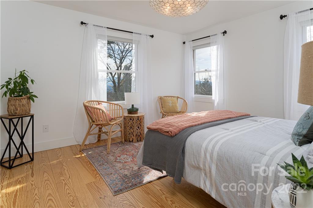 170 South Delano Road Asheville, NC 28805 - Photo 25 of 48 a bedroom with a bed and a window
