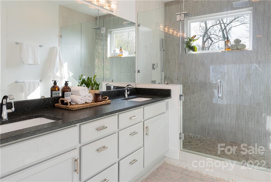 170 South Delano Road Asheville, NC 28805 - Photo 32 of 48 a sink with a mirror and a shower
