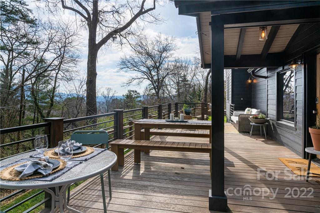 170 South Delano Road Asheville, NC 28805 - Photo 41 of 48 a view of a patio with couches table and chairs and wooden floor