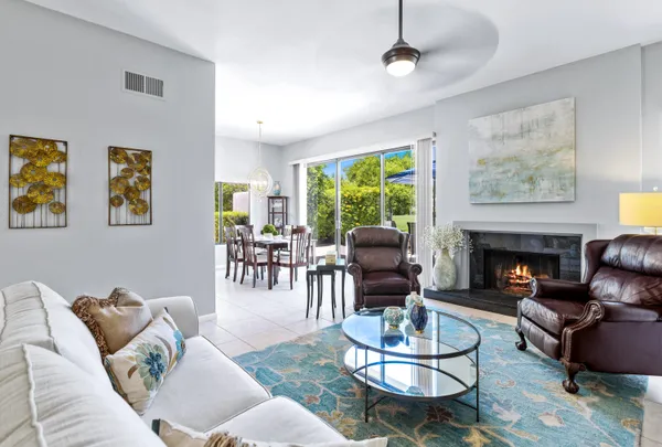 a living room with furniture a fireplace and a table