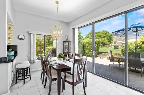 a view of a dining room with furniture large windows and wooden floor