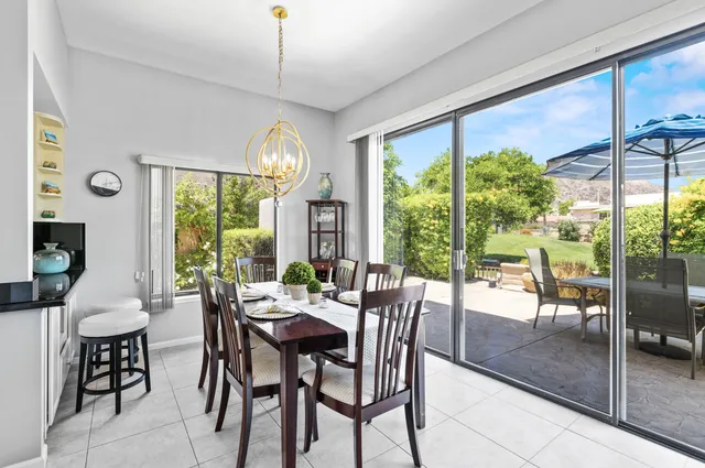 a view of a dining room with furniture large windows and wooden floor
