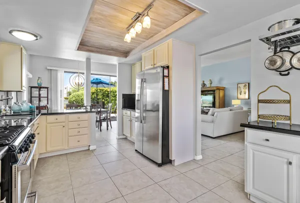 a kitchen with white cabinets and appliances