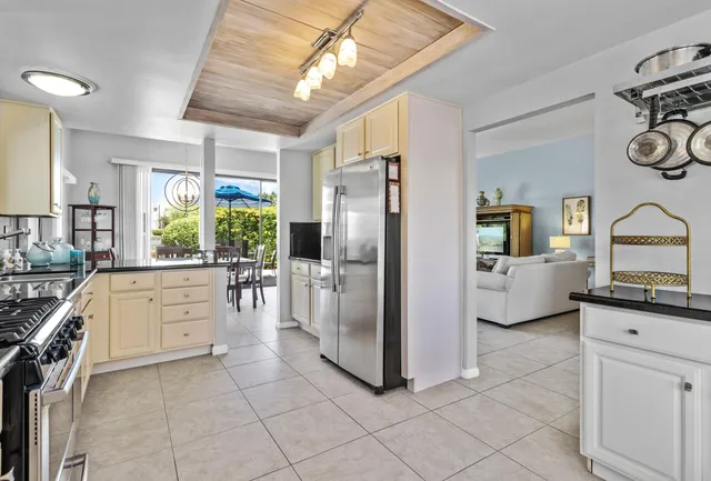 a kitchen with white cabinets and appliances