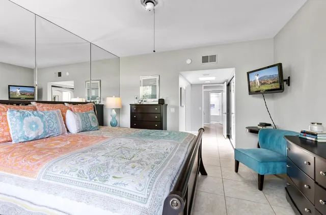 a bedroom with a bed and the view of kitchen