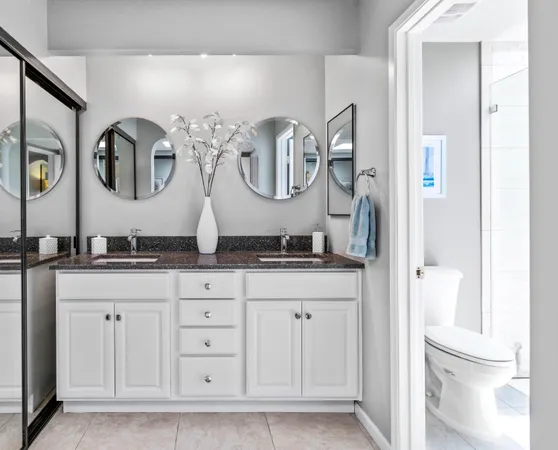 a bathroom with a granite countertop sink mirror and vanity