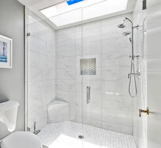 a bathroom with a toilet and shower