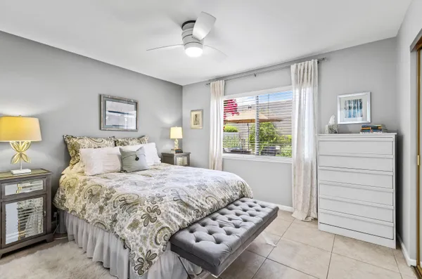 a bedroom with a bed a dresser and a window