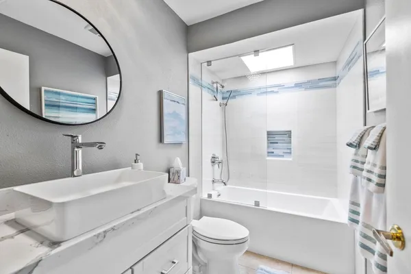 a bathroom with a sink toilet and shower