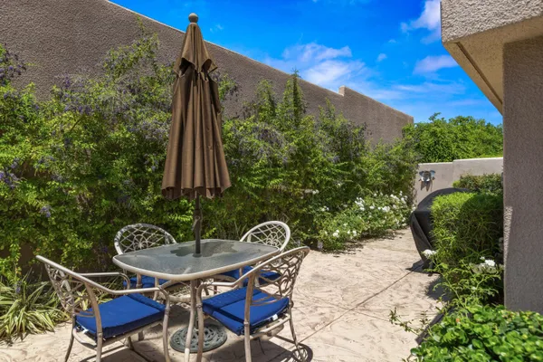 a backyard of a house with table and chairs